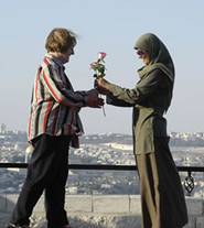 Women from different faiths in a genture of reconciliation.